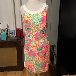 SOLD. Lilly Pulitzer bright floral dress lined in white with white bow on top …